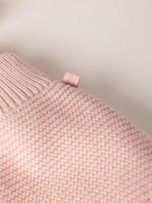 ROMPER WITH KNITTED STRAPS AND RUFFLES WITH PINK LINKS