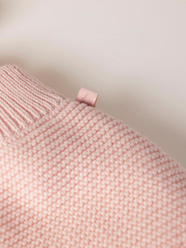 ROMPER WITH KNITTED STRAPS AND RUFFLES WITH PINK LINKS