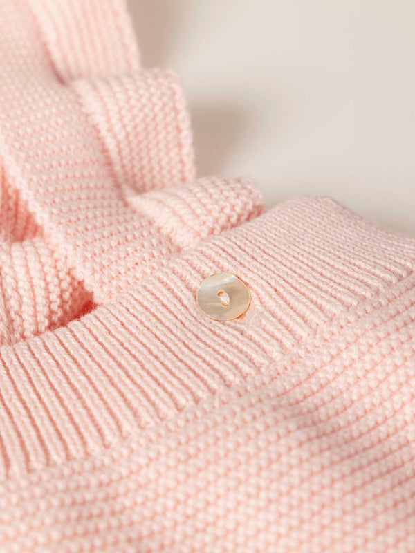 ROMPER WITH KNITTED STRAPS AND RUFFLES WITH PINK LINKS