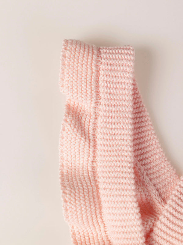 ROMPER WITH KNITTED STRAPS AND RUFFLES WITH PINK LINKS