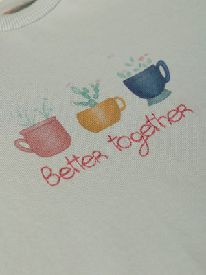 SWEATSHIRT WITH EMBROIDERED FLOWERS AND LIGHT GREEN CUFFS