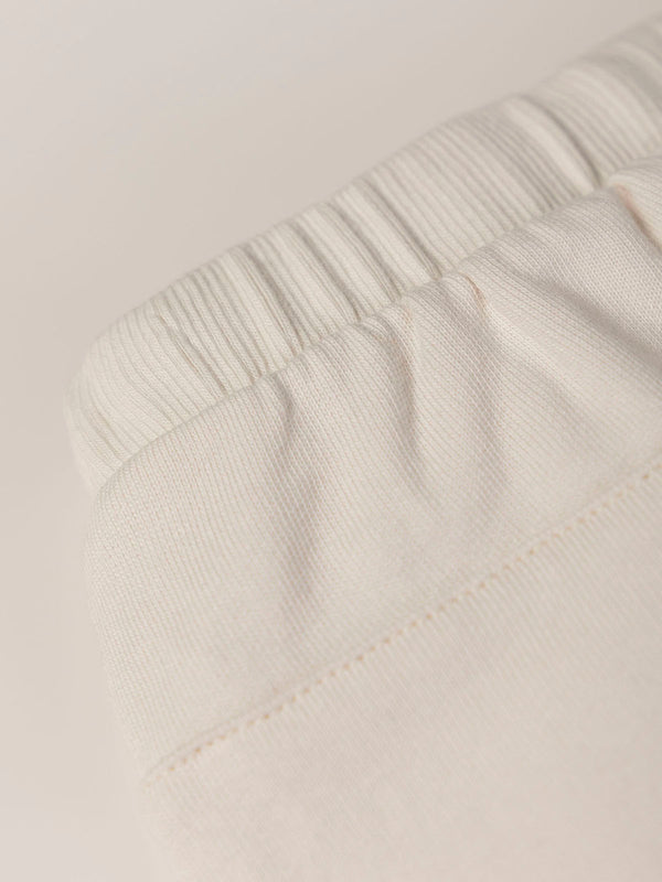 PLUSH PANTS WITH BEIGE RUFFLES AND ELASTIC PANTS