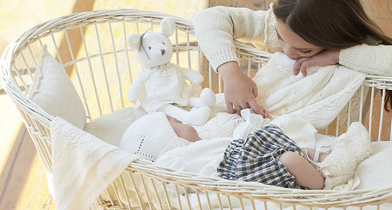 Un bebé recién nacido descansa en su cuna con ropa de Nanos